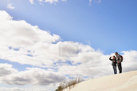 Photo for Travel, love and couple in desert for location search, view or scenery while bonding in nature. Freedom, adventure or people in sand dunes for journey, hiking or wellness, backpacking or fun in Egypt. - Royalty Free Image