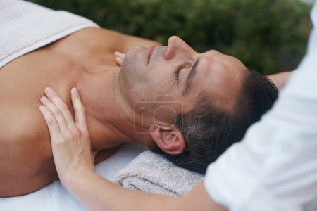 Photo for Spa, man and hands with massage for relax at resort, luxury hotel and vacation for relax and therapeutic pamper. People, masseuse and body care with shoulder treatment, hospitality and zen outdoor. - Royalty Free Image