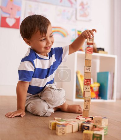 Photo for Home, boy or child with building blocks for playing and learning for development or growth in playroom. Happiness, education and playful with activity, young toddler kid and fun games for creativity. - Royalty Free Image