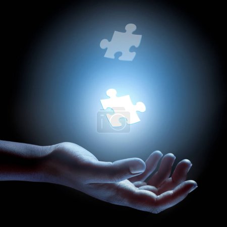 Photo for Puzzle, piece and abstract solution in hand for problem solving, challenge and planning with strategy. Jigsaw, games or shape of idea to glow in light of dark and search for innovation in business. - Royalty Free Image