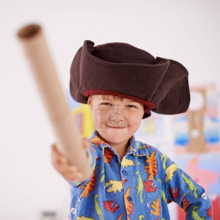 Photo for Child, portrait or costume as pirate to play in fantasy in his bedroom with telescope toy or smile. Kid sailor, proud captain or happy boy in a game with pyjamas, hat or creative monocule to sail. - Royalty Free Image