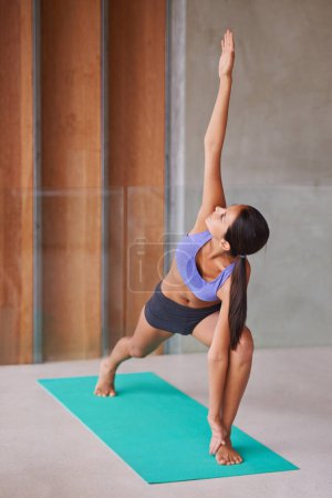 Photo for Woman, yoga and stretching with mat for pilates, workout or exercise and indoor training at home. Female person or yogi in body warm up for awareness, health and wellness or fitness at the house. - Royalty Free Image