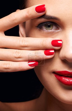 Photo for Portrait, red lips and half face of woman in studio with makeup, trendy and beauty routine. Nail polish, hand and female person with facial cosmetics treatment and manicure by black background - Royalty Free Image