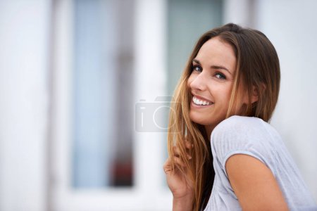 Photo for Portrait, fashion and happy woman with smile, outside and playful and relax. Confidence, stylish or hand with hair for Canadian female person, casual or contemporary outfit for travel or vacation. - Royalty Free Image