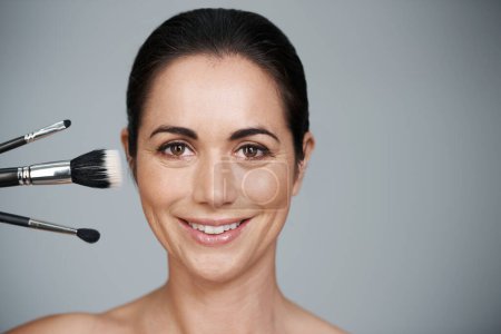 Photo for Makeup brushes, smile and portrait of woman in studio with beauty, natural and facial glow routine. Cosmetics, self care and mature female person with cosmetology tools by gray background with mockup. - Royalty Free Image