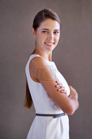 Photo for Portrait, happy woman or arms crossed on gray background for ambition and confident person by studio. French lady, designer and smile on face for career growth and positive attitude in creative job. - Royalty Free Image