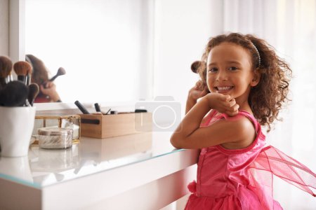 Photo for Child, mirror and portrait with makeup in bedroom for cosmetics on skin for princess and beauty on mockup for childhood. Girl, kid or tween with smile and brush in hand for happiness and children. - Royalty Free Image