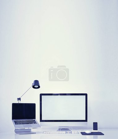 Photo for Computer, technology and workspace with mockup screen of equipment or interior on a gray studio background. Empty room with laptop, pc or desktop display of workstation, tools or tech for design. - Royalty Free Image