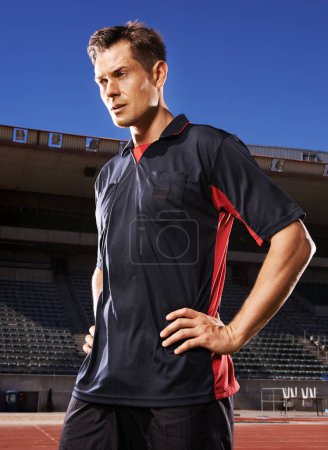 Photo for Man, fitness and confident soccer player in stadium, athlete and competitive for match or game. Male person, serious face and determined for competition, outdoors and focus for football challenge. - Royalty Free Image