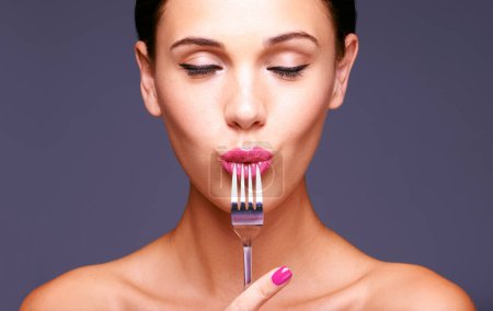 Photo for Woman, studio and fork with makeup, skin and beauty for creative diet. Model, closeup and face with lipstick, lip gloss and aesthetic for glamour and health or wellness with silverware and bliss. - Royalty Free Image