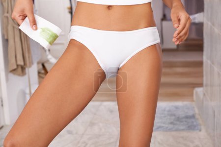 Photo for Bikini wax, legs and woman at her home for hair removal and grooming treatment in bathroom. Self care, beauty and closeup of female person with depilation routine for smooth skin at apartment - Royalty Free Image
