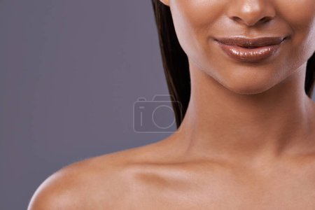 Photo for Closeup, lipstick and woman with skincare, cosmetics and dermatology on grey studio background. Person, model and girl with shine and glow with grooming routine and makeup with mouth, lips and mockup. - Royalty Free Image
