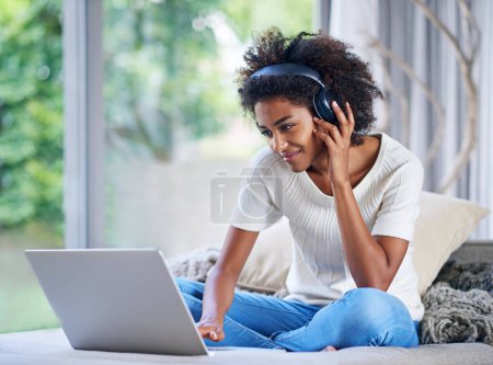 Photo for Headphones, university student and laptop at home for online education, e learning and teaching in living room. Female person, computer and black woman in house for remote class, studying or tuition. - Royalty Free Image