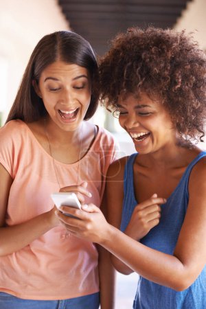 Photo for Friends, phone and laugh for meme on social media, internet and reading funny notification outdoors. Happy women, students and bonding at university, comedy and humor in conversation on app or web. - Royalty Free Image