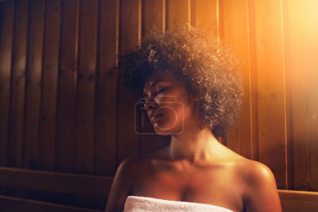 Photo for Black woman, sauna and detox treatment at spa, healing and self care with wellness and zen. Relax, calm and peace on pamper day with heat or warm bodycare, skincare and health with stress relief. - Royalty Free Image