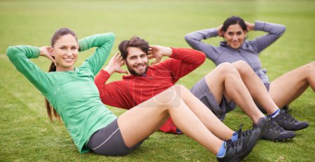 Photo for Friends, sit ups and fitness on field for portrait, training or happy for abdomen exercise in summer. People, man and women with wellness with smile, core workout and group on grass lawn in Australia. - Royalty Free Image