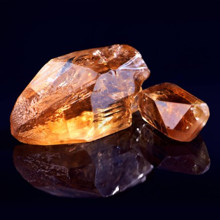 Photo for Orange stone, jewel studio by black background for natural resource, garnet or sparkle for luxury. Rock, gemstone or crystal in closeup for shine, glow and uncut mineral with reflection for wealth. - Royalty Free Image