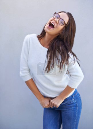 Photo for Laugh, smile and happy woman for fashion, style and clothing range isolated on gray background. Female person, lady and expression for casual outfit, eyewear and apparel with confidence in studio. - Royalty Free Image
