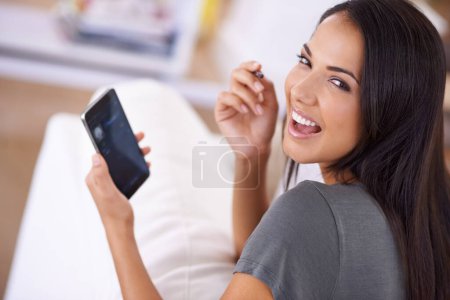 Photo for Smile, portrait and woman on a sofa with phone for social media, search or online dating communication at home. Happy, face and female person in living room with smartphone app for google it or chat. - Royalty Free Image