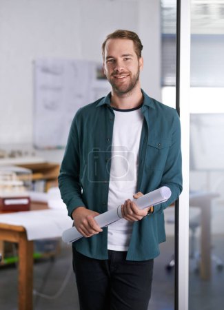 Photo for Portrait, smile and blueprint with architect man in office with documents for building, design or planning. Architecture, construction and industry with happy young developer in creative workplace. - Royalty Free Image