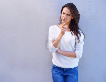 Photo for Studio, portrait and woman with doubt, point and feeling suspicious with rumor of news and opinion. Gesture, female person and girl with finger to show warning of guilty with serious decision. - Royalty Free Image