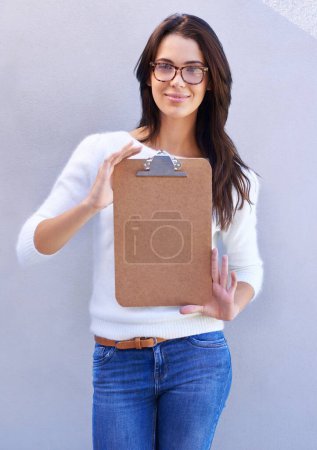 Photo for Portrait, smile and woman with clipboard to show, empty and blank to support information or documents. Studio background, female person and girl with glasses for intelligence with single form holder. - Royalty Free Image