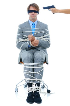 Photo for Businessman, tied up and hostage with gun on chair in kidnapped, robbery or silence on a white studio background. Young man or employee with ropes or handcuffs in crime, theft or corruption on mockup. - Royalty Free Image