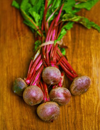 Photo for Beetroot, closeup and counter for health, wellness or organic diet on wood countertop. Vegetable, nutrition or produce for eating, gourmet and meal or cuisine with minerals or fibre for weight loss. - Royalty Free Image