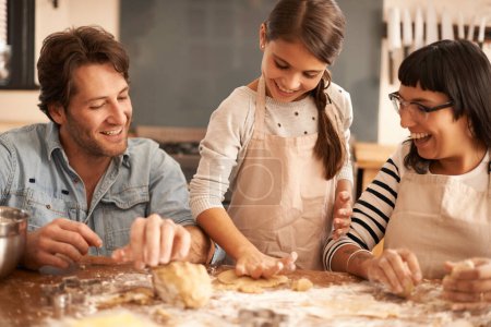Photo for Mother, father and girl with dough for cooking in kitchen with flour, happiness and teaching with support. Family, parents and child with helping, learning and bonding with baking for snack and hobby. - Royalty Free Image