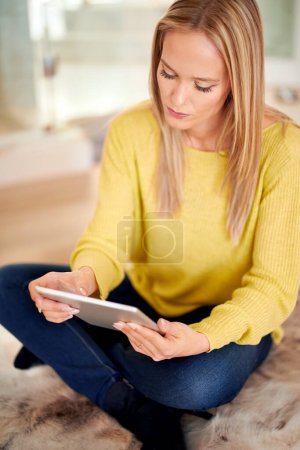 Photo for Tablet, search and woman relax on a floor with social media, streaming or subscription in her home. Digital, ebook and female person in a living room with google it, sign up or Netflix and chill app. - Royalty Free Image