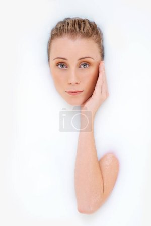 Photo for Woman, portrait and milk or bath for cosmetics, beauty and moisturize on white background. Female person, luxury spa treatment and pamper for smooth skin, dermatology and grooming for hydration. - Royalty Free Image