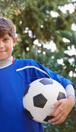 Photo for Child, portrait and soccer ball for outdoor sport or practice training or competition, exercise or fitness. Male person, face and football game in kit or cardio playing in America, workout or athlete. - Royalty Free Image