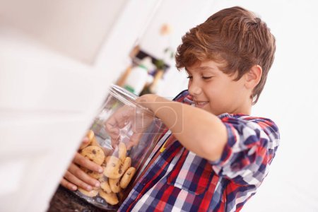 Photo for Cookie, jar and child in home eating from glass, container or happy with sweets in kitchen. House, snack and kid craving a taste of sugar and excited for biscuit and unhealthy food with energy. - Royalty Free Image