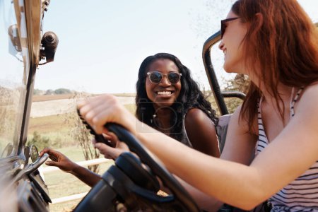 Photo for Happy women, bonding and travel on road trip in countryside and sightseeing for adventure in nature. Friends, driving and transportation in offroad vehicle on holiday outdoor in summer in california. - Royalty Free Image