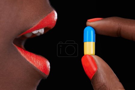 Photo for Woman, lipstick and beauty with pill for health, supplement with nail polish and bright makeup color on black background. Collagen, medicine and tablet for cosmetic care, orange lip balm and manicure. - Royalty Free Image