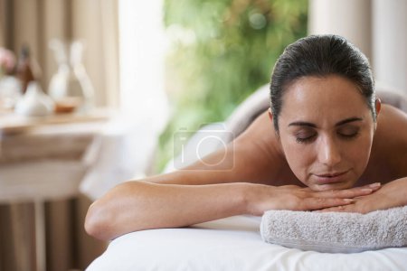 Photo for Spa, treatment and zen woman on massage table, salon and beauty therapist in wellness centre. Peaceful, smile and reflexology for body and relax, pamper and skin care for sleeping female client. - Royalty Free Image