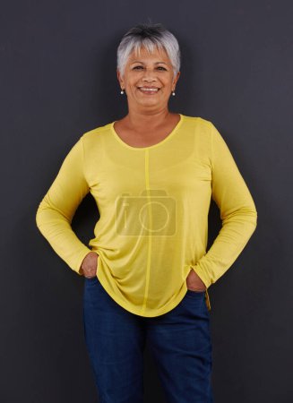 Photo for Smile, fashion and portrait of woman in studio with casual, trendy and bright tshirt for outfit. Confident, happy and senior female person from Mexico with cool style isolated by black background - Royalty Free Image