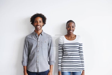 Photo for Couple, smile and portrait by white wall in fashion with confidence, casual style and model aesthetic. Black woman, and face of man with trendy apparel, edgy clothes and pride with happiness or relax. - Royalty Free Image