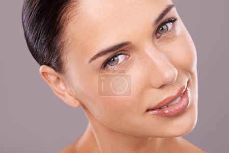 Photo for Cosmetics, studio and portrait of woman with beauty, wellness and gloss for makeup and treatment. Dermatology, salon and face of person with lipstick, foundation and facial care on grey background. - Royalty Free Image