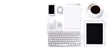 Photo for Table, studio or objects for office by white background or technology with stationary for professional job. Keyboard, cellphone or tablet by mouse for electronics, desk or paper with coffee in mockup. - Royalty Free Image