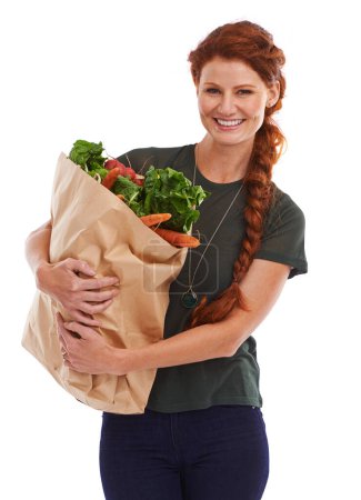 Photo for Happy woman, portrait and groceries in studio for product, discount and vegetable shopping. Person, delivery offer and smile in white background for nutrition, healthy food and fruits for diet choice. - Royalty Free Image