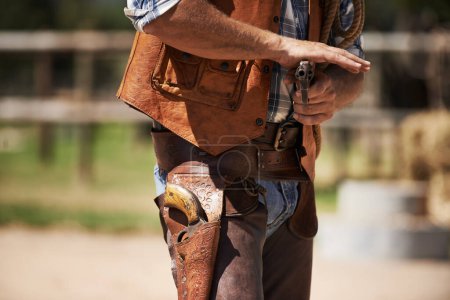 Photo for Cowboy, tough and aim gun to shoot for standoff or gunfight in duel for wild western culture in Texas. Male gunslinger or outlaw, revolver and confrontation for defense or conflict with closeup. - Royalty Free Image