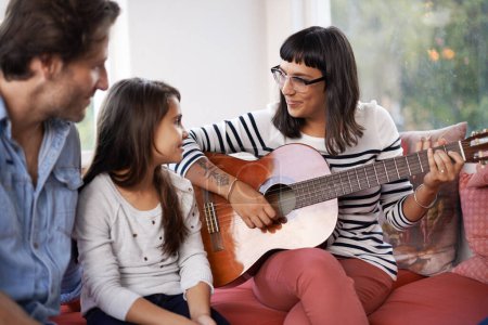 Photo for Mother, music and playing guitar for family at home, relaxing and enjoying together on couch. Performance, father and child with woman in living room, entertainment and happy with musical instrument. - Royalty Free Image
