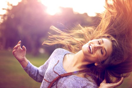 Photo for Smile, dance and hair in nature for happy woman person, freedom and excited in park. Confidence, dancer and summer sunshine or sunset with lens flare, joy and fun from good news or achievement. - Royalty Free Image
