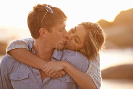 Photo for Couple, kiss and love in hug at beach, ocean waves and peace for romance in relationship. People, affection and security in marriage, sea embrace and travel together on vacation or holiday for date. - Royalty Free Image