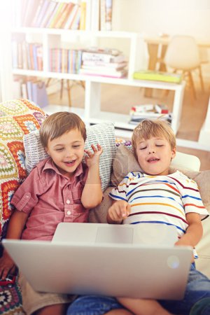 Photo for Children, laptop and siblings on a sofa with cartoon, film or streaming movie at home. Computer, learning and boy kids in a house for google it, search or ebook storytelling, app or Netflix and chill. - Royalty Free Image