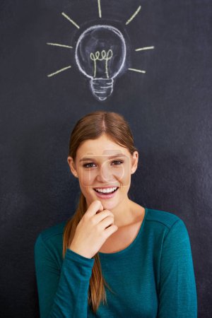 Photo for Portrait, thinking and woman with light bulb on chalkboard for inspiration, brainstorming and problem solving. Creative, question and person on background with icon for ideas, thoughtful and planning. - Royalty Free Image
