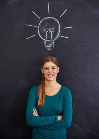 Photo for Idea, portrait and woman with light bulb on chalkboard for inspiration, brainstorming and problem solving. Creative, question and person on background with icon for solution, thinking and planning. - Royalty Free Image