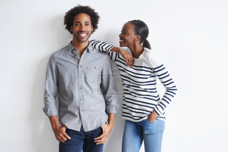Photo for Couple, hug and portrait by white wall in fashion with confidence, casual style and model aesthetic. Black woman, and face of man with trendy apparel, edgy clothes and happiness with relax or romance. - Royalty Free Image