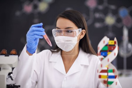 Photo for Science, test tube and woman in mask for medical research, experiment and dna. Scientist, glasses and professional with vial for chemistry, biology and check liquid sample for laboratory analysis. - Royalty Free Image